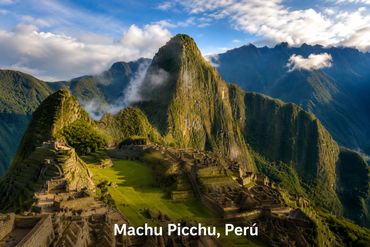 Ancient Machu Picchu ruins nestled in lush Peruvian mountains under a partly cloudy blue sky.