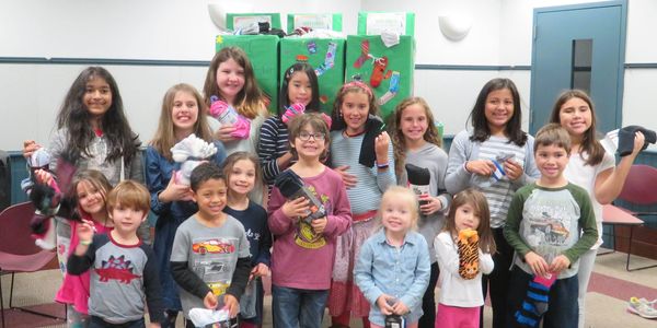 Each Oct, kids do community service by showing that the smallest act of love, donating a pair of socks, can make a big difference for the homeless - Socktober.