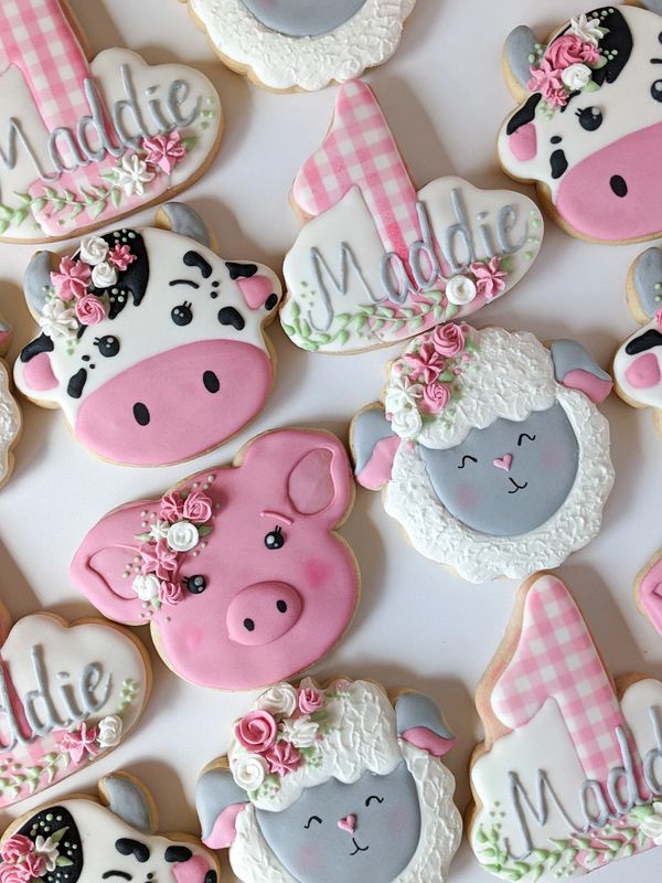 Farm sugar cookies including a cow, sheep, pig, and the number 1 with a gingham pattern and florals