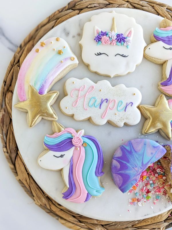 Unicorn sugar cookies with a shooting star sugar cookie, unicorn cookie, and sprinkle bomb cookie