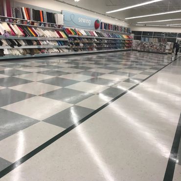 Fabric store with neatly arranged colorful rolls of fabric.