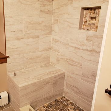 tile shower with niche and bench