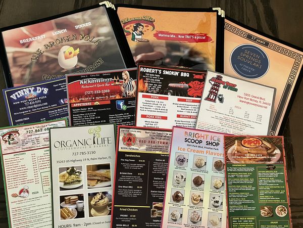 A collection of colorful restaurant menus from various eateries.