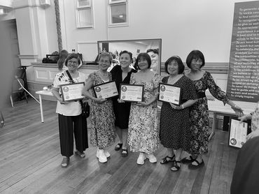 CommunityClicks graduates receiving their certificates asmod tablet devices