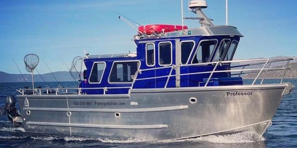 A sturdy fishing boat named Professor on calm waters under clear skies.