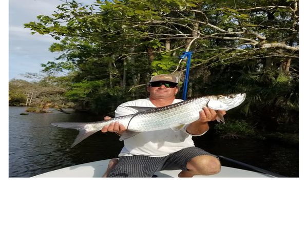 client with a tarpon he caught during his inshore fishing trip