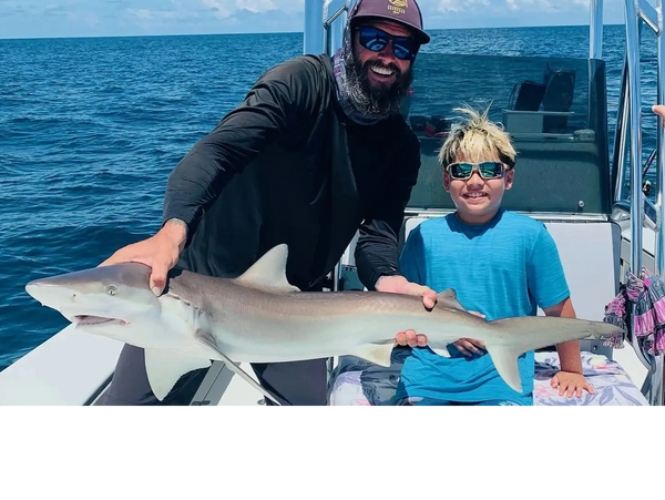 cient with a bullshark caught on a shark fishing trip