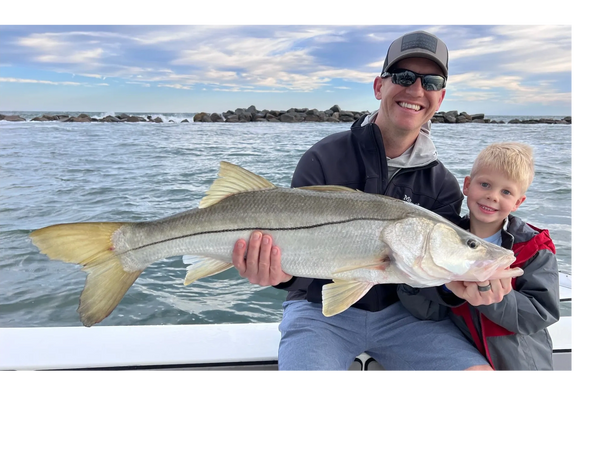 clients with a snook caught while inshore fishing