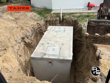 Concrete septic tank installed in ground for home wastewater system