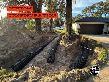 Custom drainfield installation configured around trees and permanent structures