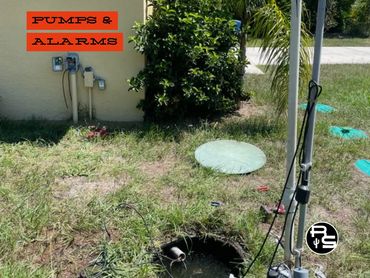 Submersible septic pump and alarm system installed in residential septic tank
