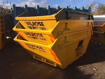 Commercial skips for hire. piled high skips with wilrose logo.