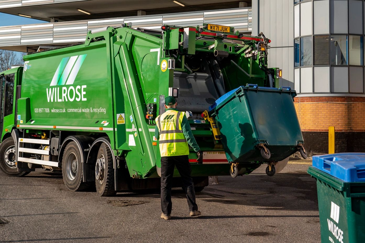 Dustcart in sutton loading commercial waste.  bin is halfway up and the general waste is going in.