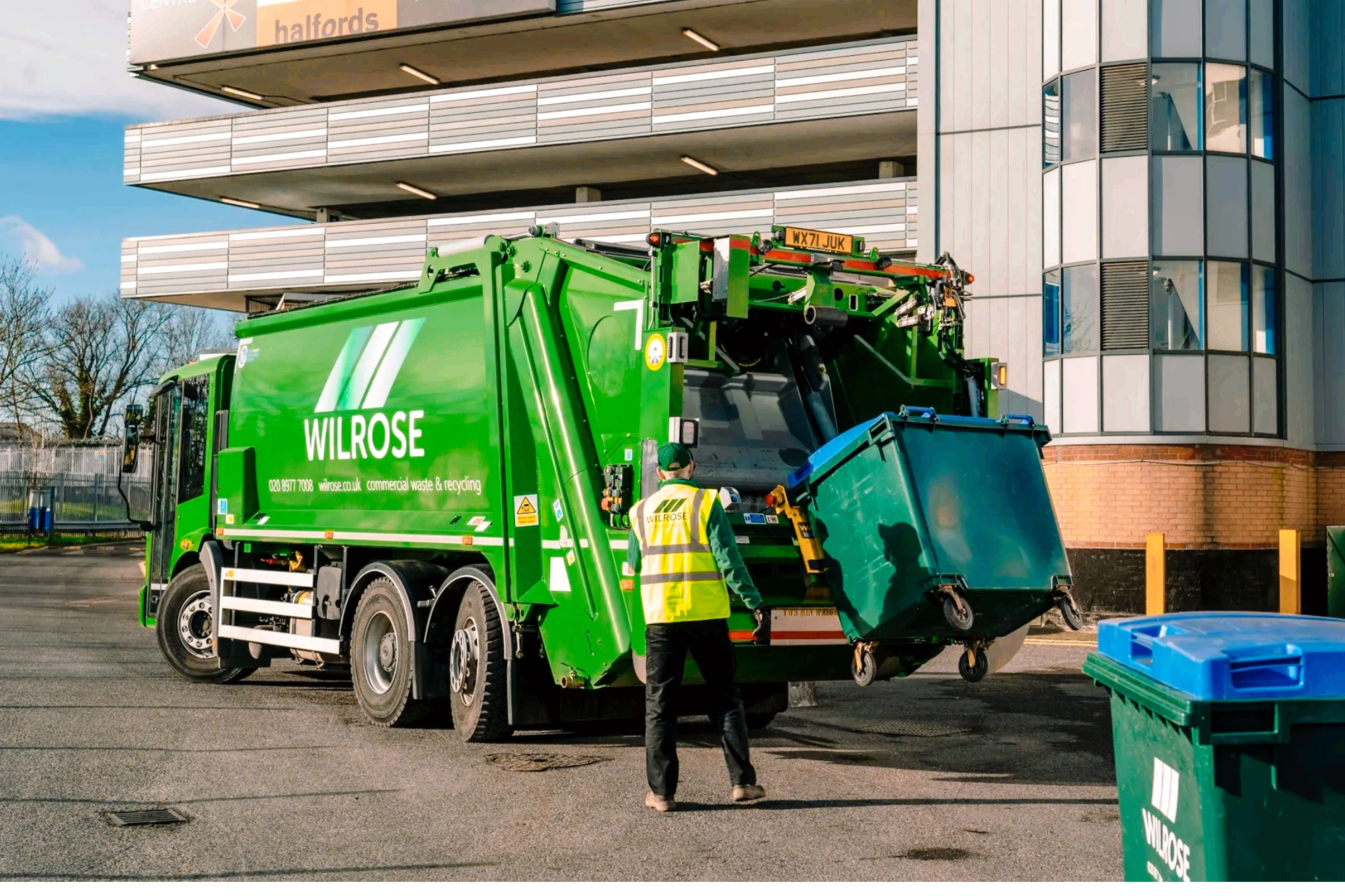 Emptying of wheelie bin into back of commercial dustcart in Wimbledon.