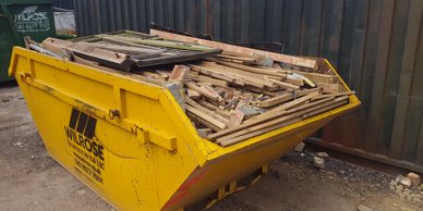 Wood skips from Wilrose.  8 yard yellow skip filled with wood.