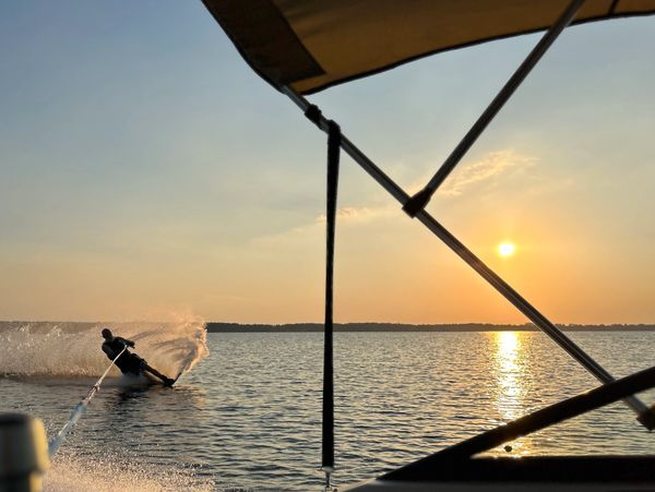 Man wakeboarding behind a boat