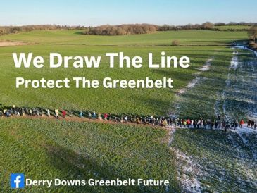 A large group draws a line in a green field to protect the greenbelt.