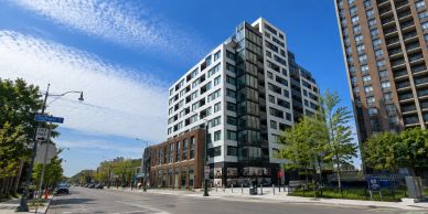 Modern multi-story building with clear blue sky in an urban setting.