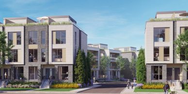 Modern residential buildings with landscaped surroundings under a clear sky.