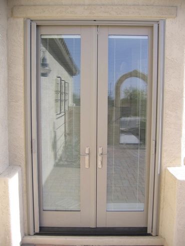 Modern beige double glass doors with blinds.