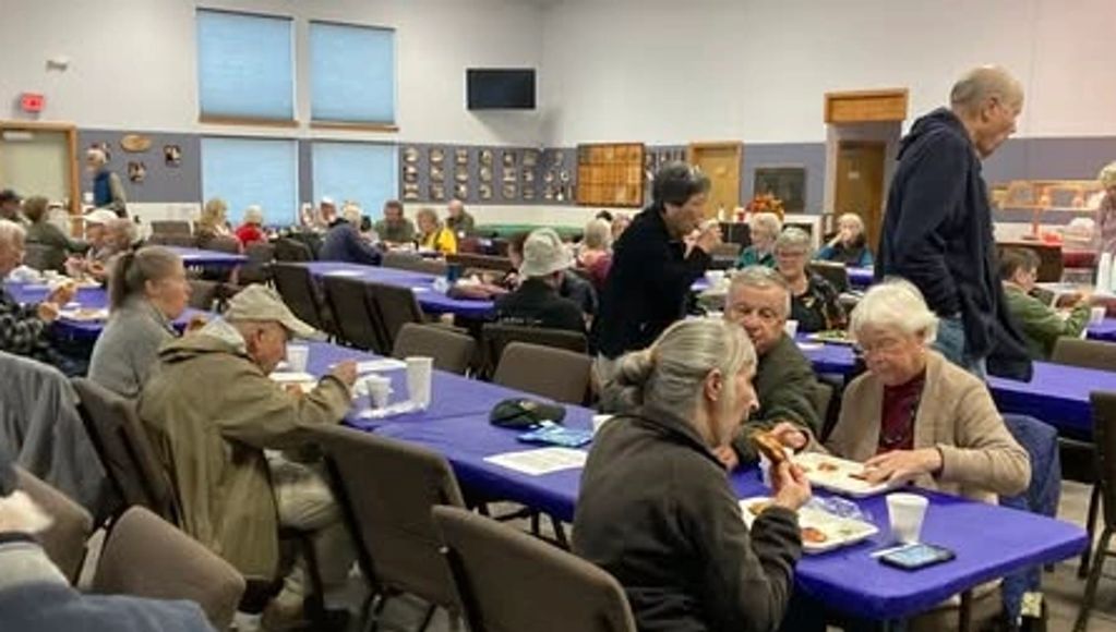 Seniors sitting at tables having lunch