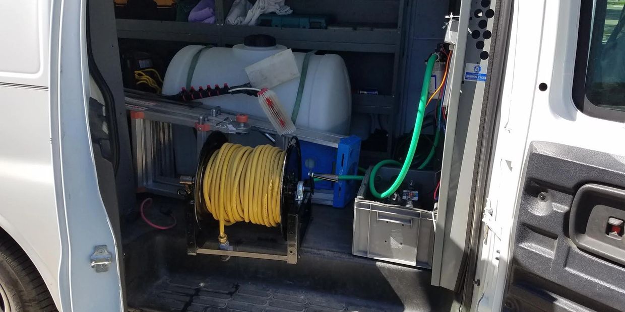 Tank and window washing hose inside of van
