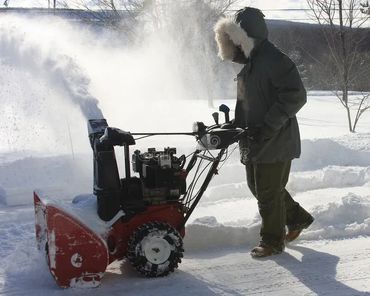 Man using a big snow blower