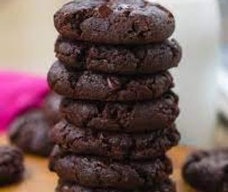 Stacked brownie cookies on wooden table