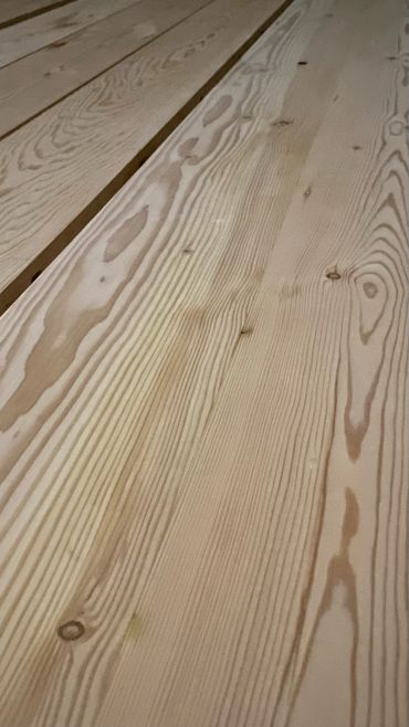 Surfaced reclaimed douglas fir being glued up for dining table surface.