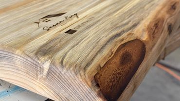 Live edge barnwood studs transformed into a charcuterie board for Susan King Realty.