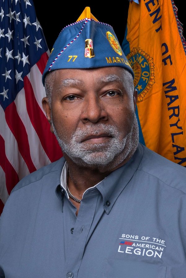 Veteran in Sons of the American Legion uniform with Maryland and US flags.