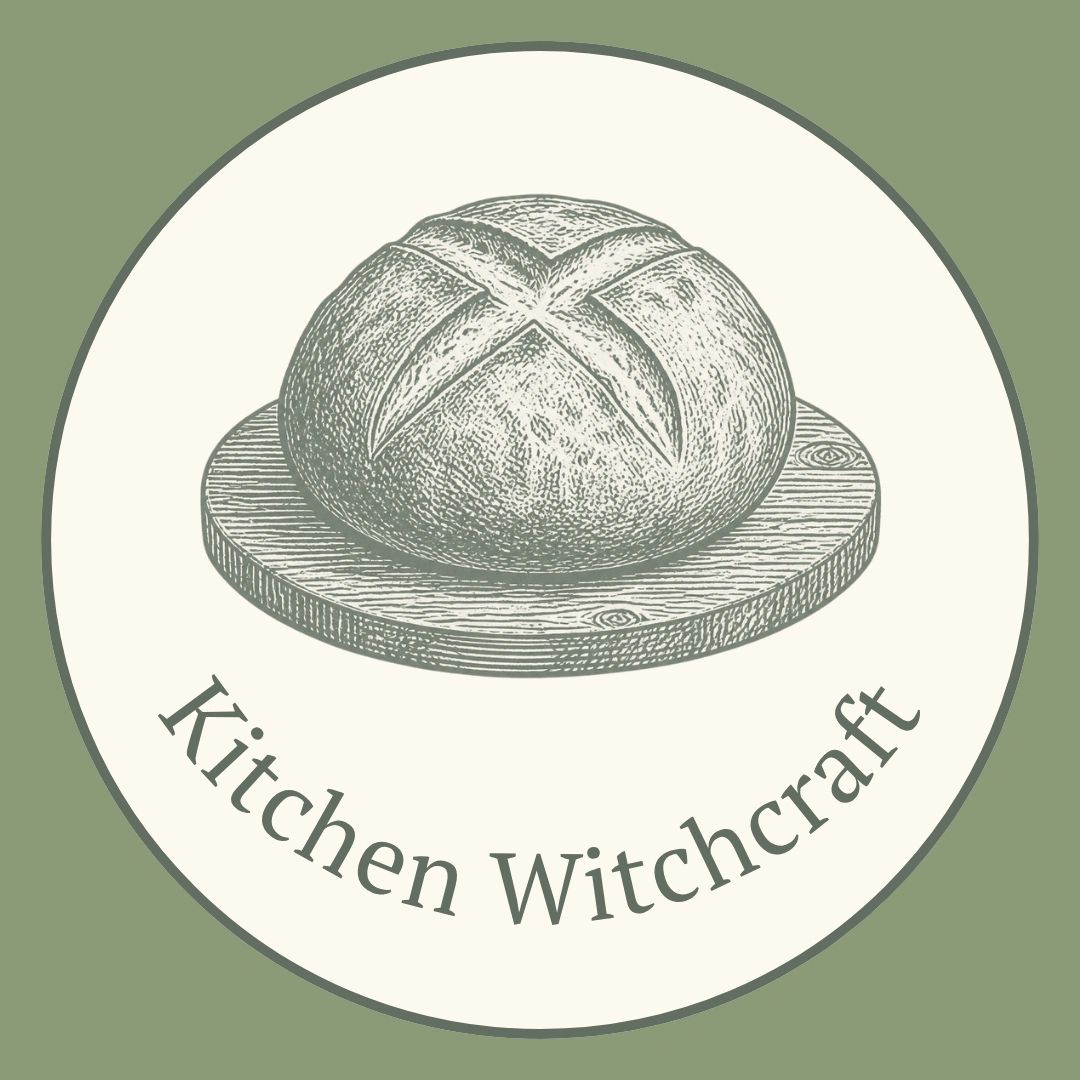 Logo with bread on a wooden board and text 'Kitchen Witchcraft'.