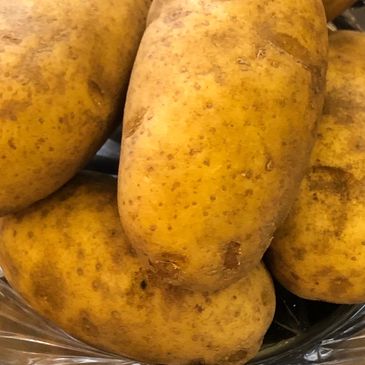 Five potatoes in a glass bowl