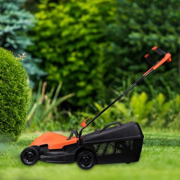 Orange and black lawn mower on green grass with blurred background.