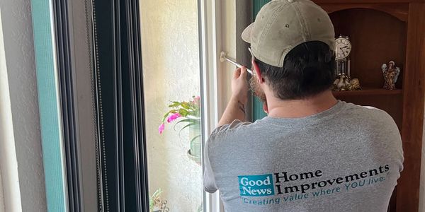 Photo of Good News Home Improvement window installation man caulking a window.