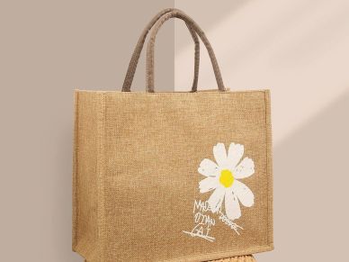 Eco-friendly jute bag with a white daisy design and text.