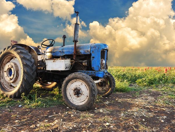 Traditional equipment in open farmland representing modernizing business operations with M365 Azure