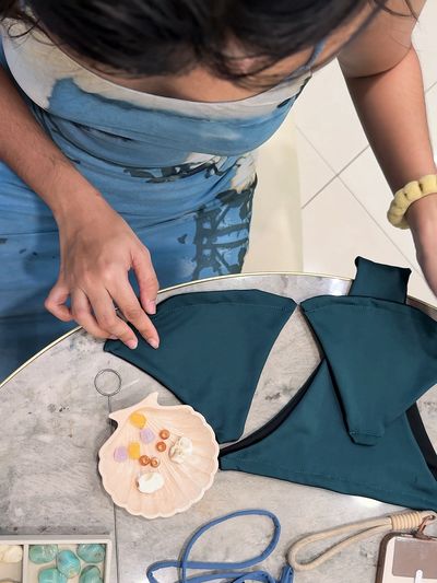 Shellf made girl customizing her bikini at a cafe