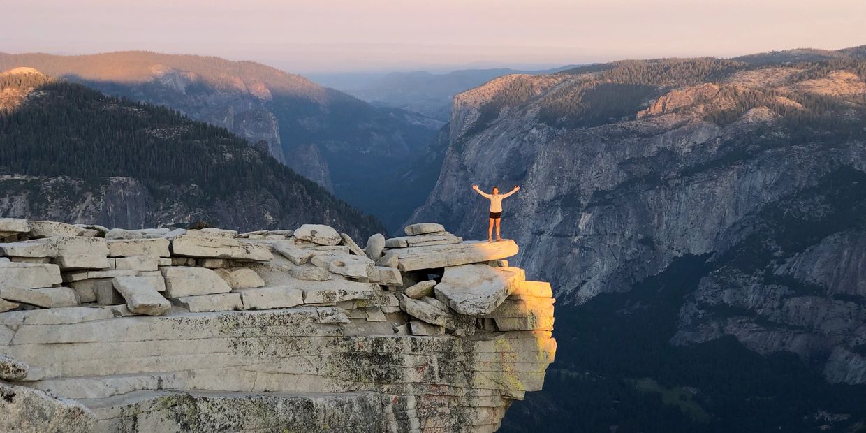 Ruth embracing the beauty of Half Dome at sunrise.