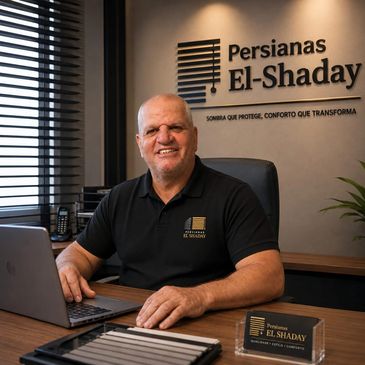 Homem sorridente sentado em escritório moderno de persianas.