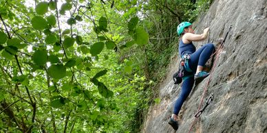 Climber taking part in an outdoor sport climbing learn to lead course
