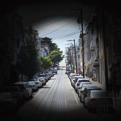 On a black background, there is a black-and-white circular image of a street, representing tunnel vi