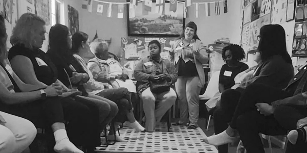 Group meeting in a room with international flags.
