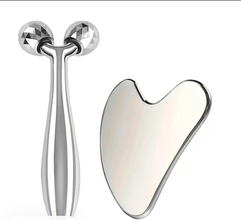 Two silver facial massage tools on a white background.