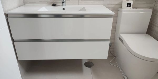 conjunto de lavamanos y retrete blanco de un baño