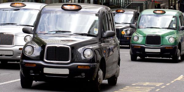 Street with a group of UK taxi cars