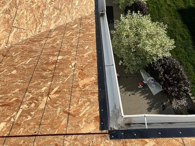 Installing drip edge flashing to guide water into gutters and prevent roof deck damage.