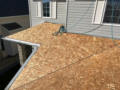 Inspecting a clean, dry roof deck to assess structural integrity before installation.