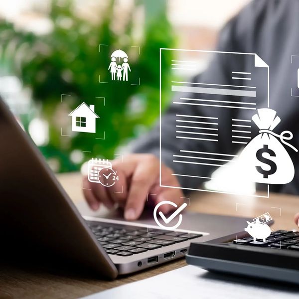 Person managing finances on laptop with digital icons for insurance and savings.