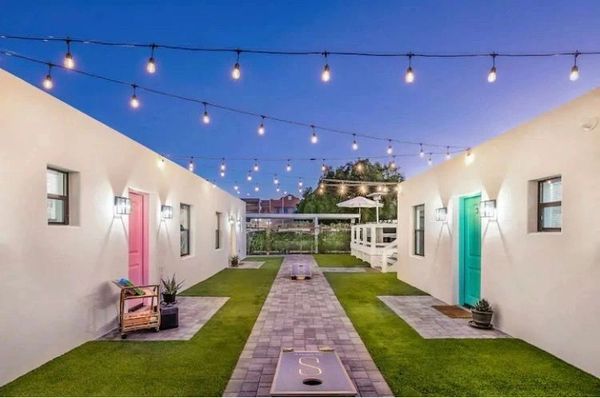 Outdoor space featuring a court yard, raised patio, and bistro lights.  Also outdoor games.